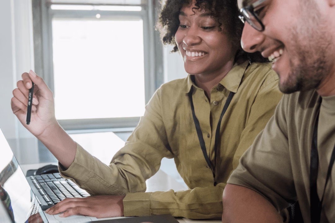 Two people looking at laptop